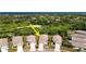 Aerial view of home showing roof, driveway, and landscaping nestled in a tropical neighborhood near the ocean at 2325 Pleasant Hill Ln, Holiday, FL 34691