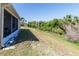 Side view of a spacious backyard that provides plenty of room for recreation and landscaping possibilities at 2325 Pleasant Hill Ln, Holiday, FL 34691