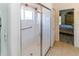Modern tiled shower featuring a glass door and hand rail at 2325 Pleasant Hill Ln, Holiday, FL 34691
