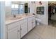 Bathroom with double sinks and shower, near a closet with organized clothes at 2325 Pleasant Hill Ln, Holiday, FL 34691
