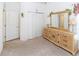 Cozy bedroom with ample storage including mirrored dresser and closet space at 2325 Pleasant Hill Ln, Holiday, FL 34691