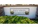 Key Vista Clubhouse signage with seashell emblems surrounded by manicured landscaping at 2325 Pleasant Hill Ln, Holiday, FL 34691