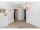 Open-concept dining area features tiled flooring and a hanging chandelier at 2325 Pleasant Hill Ln, Holiday, FL 34691