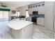 Spacious kitchen featuring a marble island, modern appliances, and bright, neutral cabinetry at 2325 Pleasant Hill Ln, Holiday, FL 34691