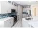 Well-appointed kitchen boasts stainless steel appliances, stylish backsplash, and ample storage space at 2325 Pleasant Hill Ln, Holiday, FL 34691
