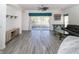 Bright living room with sliding doors that lead to screened patio; features a ceiling fan at 2325 Pleasant Hill Ln, Holiday, FL 34691