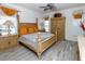 Well-decorated primary bedroom with wood-look tile flooring and ceiling fan at 2325 Pleasant Hill Ln, Holiday, FL 34691