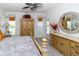 Well-decorated primary bedroom with wood-look tile flooring and ceiling fan at 2325 Pleasant Hill Ln, Holiday, FL 34691