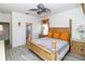 Well-decorated primary bedroom with wood-look tile flooring and ceiling fan at 2325 Pleasant Hill Ln, Holiday, FL 34691