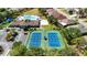 Aerial view showcasing the community's pristine tennis courts, perfect for recreation and friendly matches at 2325 Pleasant Hill Ln, Holiday, FL 34691