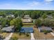 Aerial view showcasing a neighborhood with tree-lined streets and well-maintained homes, providing a serene living environment at 27198 Simona Ave, Brooksville, FL 34602