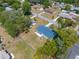 This aerial view shows the property located in a verdant neighborhood at 27198 Simona Ave, Brooksville, FL 34602