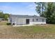 Back of house with a sliding glass door and white paint at 27198 Simona Ave, Brooksville, FL 34602