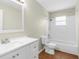 Bathroom with white vanity, tile floors, shower-tub combo, and natural light at 27198 Simona Ave, Brooksville, FL 34602