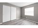 Bedroom with a closet, window, and light wood floors at 27198 Simona Ave, Brooksville, FL 34602