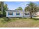 The exterior of this home features an updated roof, fresh paint and charming curb appeal at 27198 Simona Ave, Brooksville, FL 34602