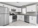 The kitchen features new appliances, ample white cabinets, and granite countertops for a modern cooking space at 27198 Simona Ave, Brooksville, FL 34602