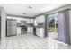 Bright kitchen featuring stainless appliances, ample white cabinets, granite countertops, and a sliding door to the patio at 27198 Simona Ave, Brooksville, FL 34602