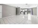 Bright living room with tile flooring, a sliding door, and ample space, seamlessly connected to the adjacent kitchen area at 27198 Simona Ave, Brooksville, FL 34602