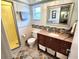 Bathroom with tiled shower, vanity, updated countertop, decorative mirror and storage at 273 Gulfport Ln, Spring Hill, FL 34608