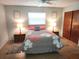 Cozy bedroom with a queen bed, ceiling fan, and matching nightstands at 273 Gulfport Ln, Spring Hill, FL 34608