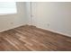 Bright bedroom with laminate flooring and a window providing natural light at 273 Gulfport Ln, Spring Hill, FL 34608