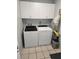 Efficient laundry room with a washer, dryer, and storage cabinets at 273 Gulfport Ln, Spring Hill, FL 34608