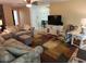 Comfortable living room with hardwood floors, fan, light walls, and neutral colored furniture at 273 Gulfport Ln, Spring Hill, FL 34608