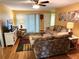 Inviting living room with stylish furniture, ceiling fan, and sliding glass door to the backyard at 273 Gulfport Ln, Spring Hill, FL 34608