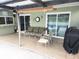 Covered patio with outdoor seating, perfect for entertaining at 273 Gulfport Ln, Spring Hill, FL 34608