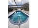 Covered outdoor pool with clear blue water, great for swimming laps and relaxing at 273 Gulfport Ln, Spring Hill, FL 34608