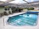 Outdoor space featuring a pool, covered lanai, and comfortable seating for relaxing and entertaining at 273 Gulfport Ln, Spring Hill, FL 34608