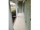 Covered porch area with painted white columns and an exterior with painted block at 273 Gulfport Ln, Spring Hill, FL 34608