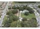 Aerial view of community park with a pool, playground, and green spaces amidst mature trees and neighborhood streets at 2815 Dudley Ave, Odessa, FL 33556