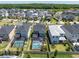 Aerial view of neighborhood featuring fenced backyards, green spaces and community pool at 2815 Dudley Ave, Odessa, FL 33556