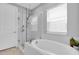 Serene bathroom with a soaking tub, a glass-enclosed shower, and plenty of natural light at 2815 Dudley Ave, Odessa, FL 33556