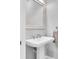 Bathroom with a pedestal sink, elegant mirror, and a towel bar at 2815 Dudley Ave, Odessa, FL 33556