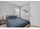 Modern bedroom with a bed frame, bedside tables, and a bright window with natural light at 2815 Dudley Ave, Odessa, FL 33556