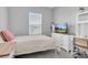 Bright bedroom featuring neutral walls, a window for natural light, and a white dresser and desk at 2815 Dudley Ave, Odessa, FL 33556