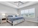 Tranquil main bedroom with tray ceiling, ceiling fan and large window at 2815 Dudley Ave, Odessa, FL 33556