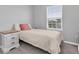 Cozy bedroom with a twin bed, soft linens, and a bright window at 2815 Dudley Ave, Odessa, FL 33556