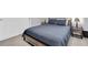 Cozy bedroom features a bed with a modern frame, stylish bedding, and matching end tables with lamps at 2815 Dudley Ave, Odessa, FL 33556