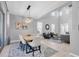 Dining room features high ceilings, stylish light fixture, and open layout to the living space at 2815 Dudley Ave, Odessa, FL 33556