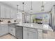 Contemporary kitchen featuring stainless steel appliances, white cabinets, and a spacious island with seating at 2815 Dudley Ave, Odessa, FL 33556