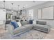 Open-concept living space features a large sofa and view to the modern kitchen and pendant lights at 2815 Dudley Ave, Odessa, FL 33556