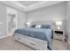 Spacious main bedroom featuring a tray ceiling, ceiling fan, and a glimpse of the en-suite bathroom at 2815 Dudley Ave, Odessa, FL 33556