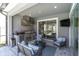 Outdoor kitchen featuring a built-in grill, stainless steel appliances, comfortable seating, and seamless access to pool at 2815 Dudley Ave, Odessa, FL 33556