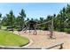 Community playground with seesaws, climbing frames and wood chip surface, surrounded by lush greenery and open space at 2815 Dudley Ave, Odessa, FL 33556
