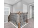 Bright, carpeted staircase featuring wooden railings and black iron spindles at 2815 Dudley Ave, Odessa, FL 33556