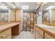 Bathroom featuring neutral cabinets, a large mirror, and a shower/tub combination with a curtain at 3029 Harrow Rd, Spring Hill, FL 34606